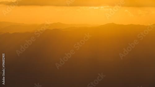 Golden sky with sunlight and the Mountains in sunset.