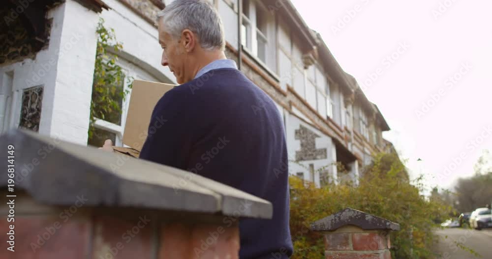 4K Mature couple moving boxes into new home with help from removals workers. Slow motion. 4K Mature couple moving boxes into new home with help from removals workers. Slow motion.