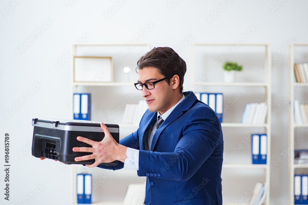 Businessman angry at copying machine jamming papers