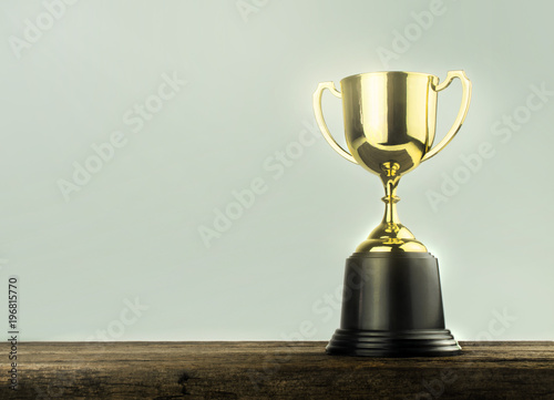 champion golden trophy placed on table .