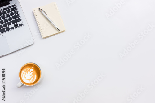 White office workspace with eye glasses,laptop,smart phone and cup of coffee.Top view with copy space.