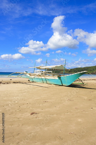 A traditional Philippine boat on the beach of Nagtabon. The island of Palawan. Philippines.