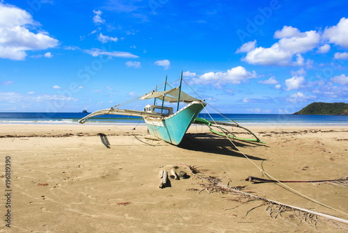A traditional Philippine boat on the beach of Nagtabon. The island of Palawan. Philippines.