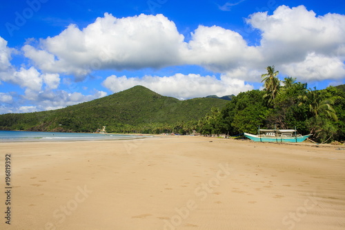 A traditional Philippine boat on the beach of Nagtabon. The island of Palawan. Philippines.