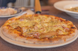 ham and cheese pizza on table.