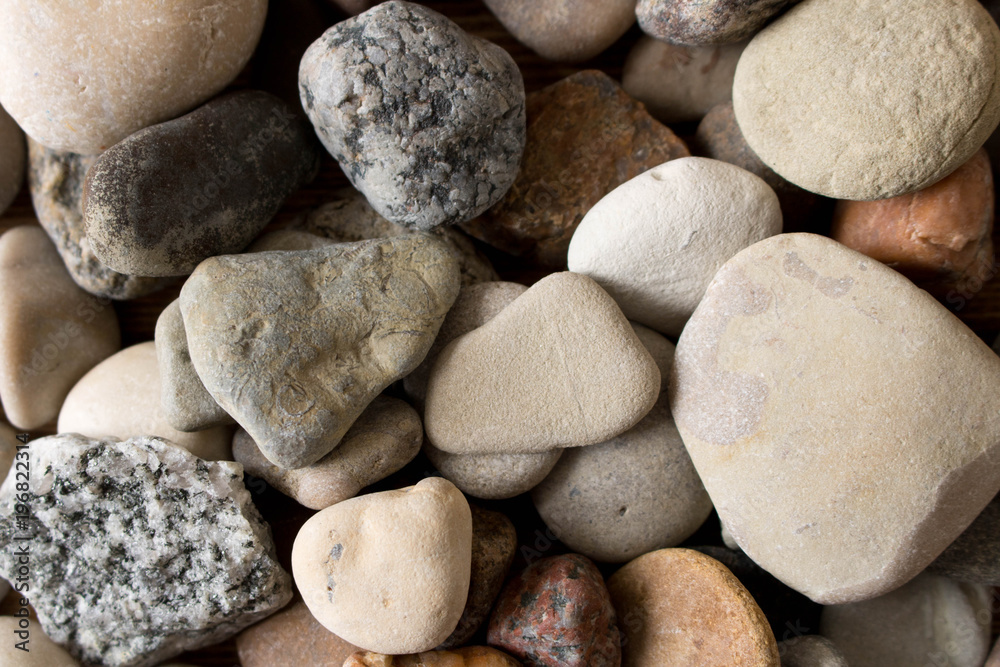 A lot of sea pebbles scattered around the table A lot of sea pebbles scattered around the table