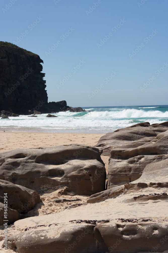 Rocky outcrop at the beach on a sunny summer day