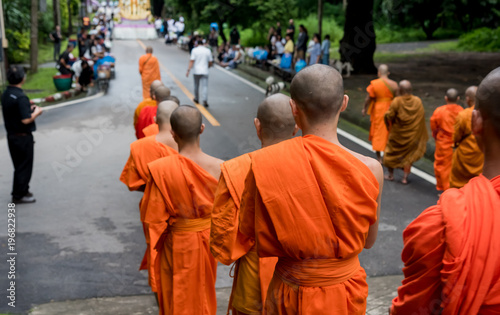  unrecognizable monk walking on street.