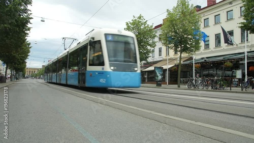 GOTHENBURG, SWEDEN - A BLUE CITY TRAM PASSES ON AVENYN STREET