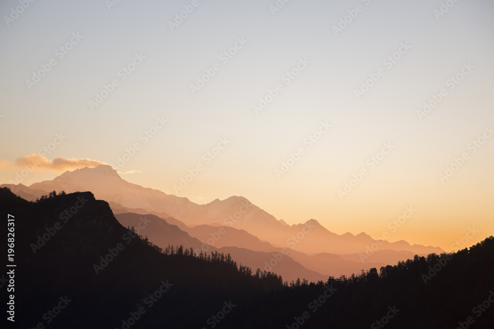 sunset throuh alpine mountin layers