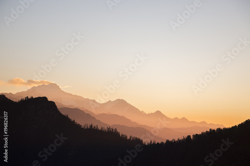 sunset throuh alpine mountin layers