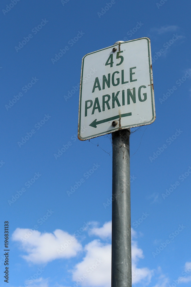 green and white 45 degree Angle Parking sign in a blue sky