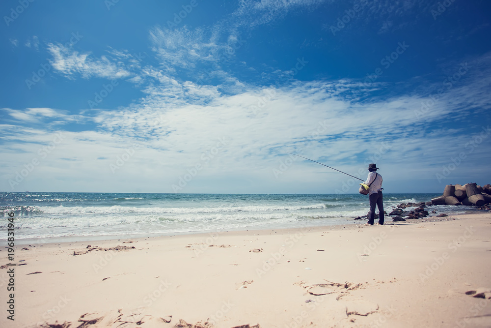 fisherman fishing in the beach sunny day