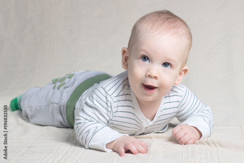 Baby boy playing, lying, smiling