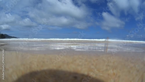Little girls playing with surfboard on sea water, sand beach island, family summer vacation 