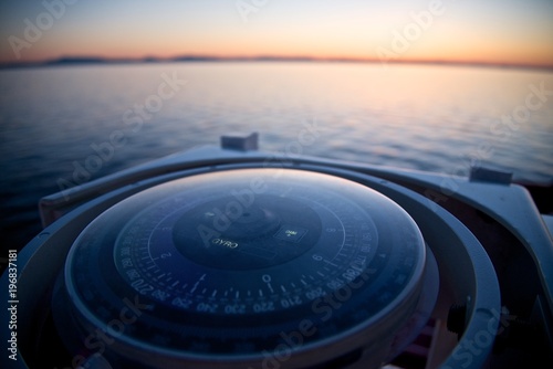 Mariner's compass on the early dawn background.