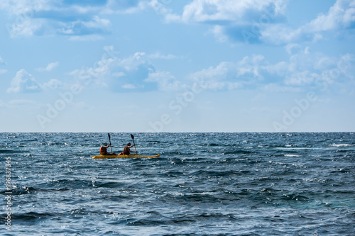 Sailing on sea kayaks. A young couple traveling on kayaks. Active rest on the water.