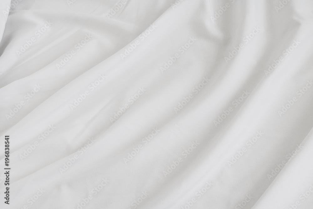 Fototapeta premium Crumpled of bedding sheet background. White fabric material surface.