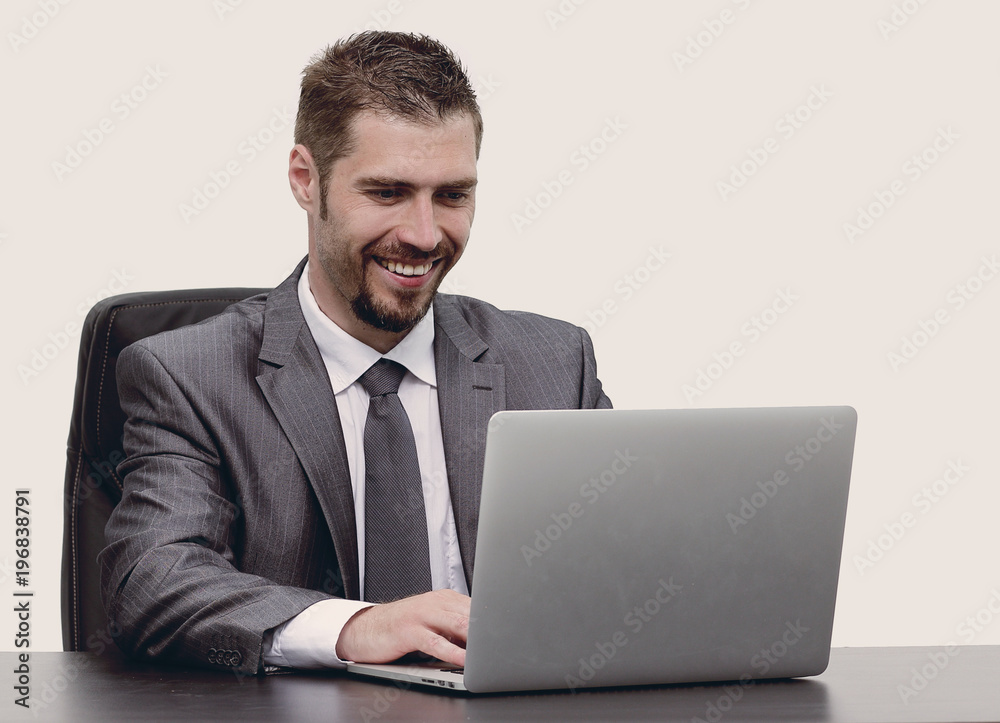 closeup.happy businessman working on laptop, sitting at desk closeup.happy businessman working on laptop, sitting at desk