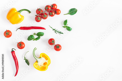 Vegetables on white background. Frame made of fresh vegetables. Tomatoes, peppers, green leaves. Flat lay, top view, copy space, square
