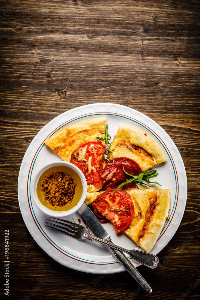 Pizza with salami and vegetables Pizza with salami and vegetables