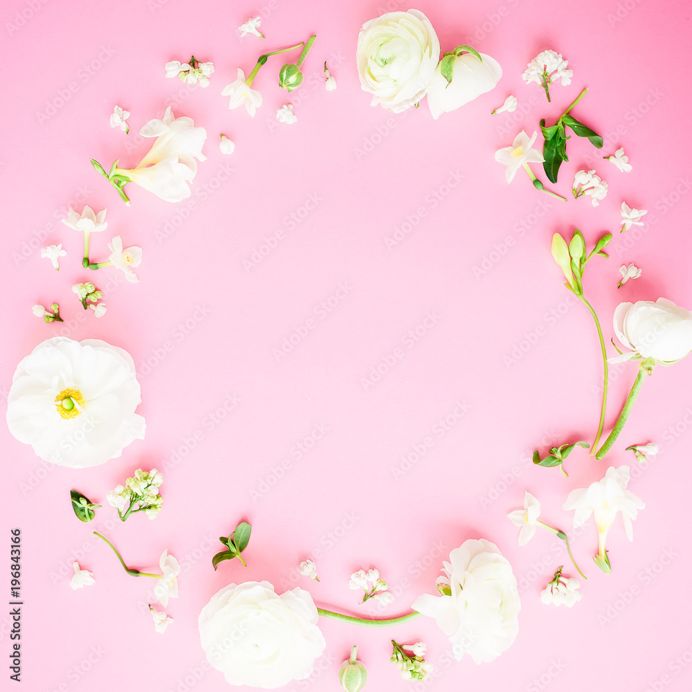 Floral round frame of white flowers on pink background. Flat lay, top view. Pastel background.