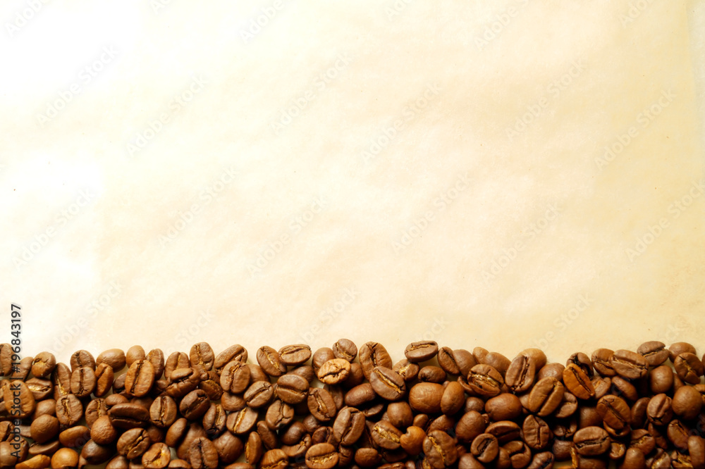 Coffee beans on old burnt paper background