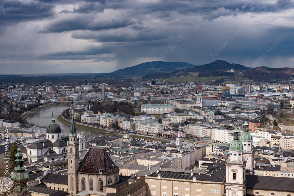 Winter skyline of Salzburg at the background of high mountains Alps, view from above. Austria, Salzburg city, Europe. 