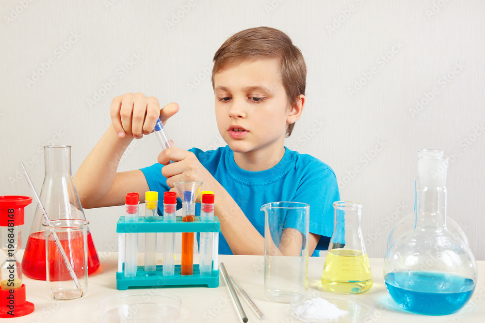 Little smart scientist doing chemical experiments in the laboratory Little smart scientist doing chemical experiments in the laboratory