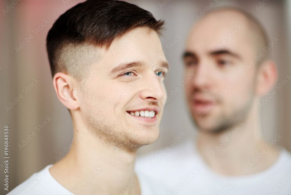 Happy young man with short cut hair and his bald gay partner on background  Stock Photo | Adobe Stock
