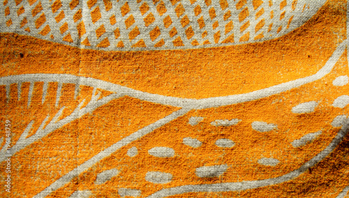 closeup photo of a yellow block print artwork on cotton fabric