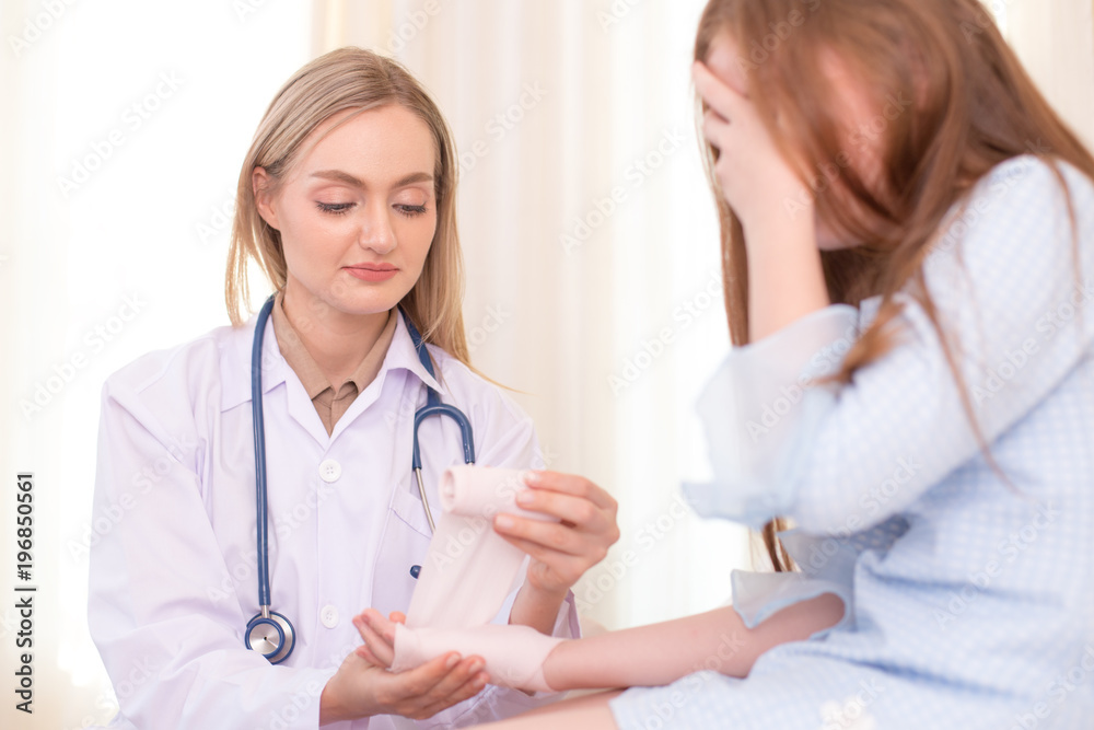 Female doctor checking hand of little patient. People with health care concept Female doctor checking hand of little patient. People with health care concept