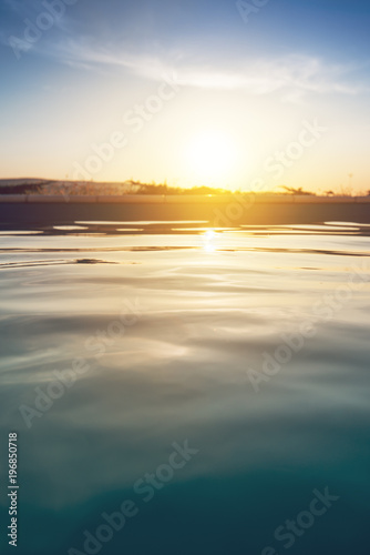Outdoor swimming pool in sunset