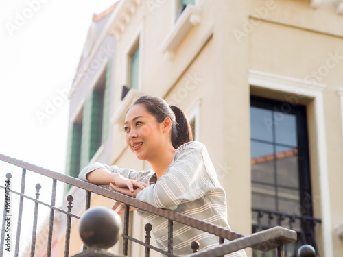 Woman standing outdoor for sightseeing and relax in a warm day.