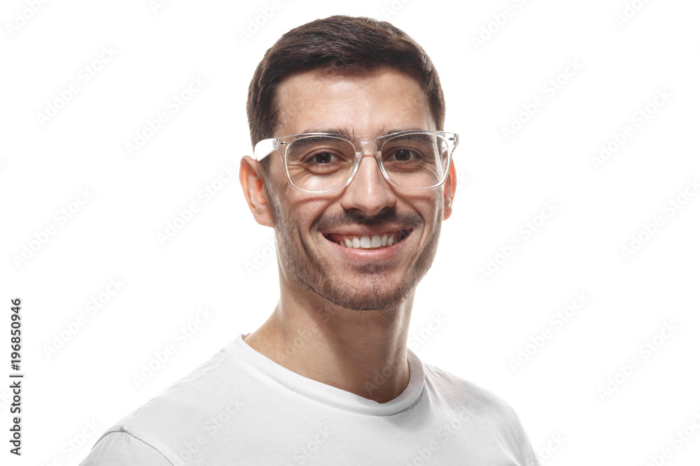 Joyful modern optimistic man smiles broadly, shows perfect teeth isolated on white background. Positive emotions, facial expressions and happiness concept.