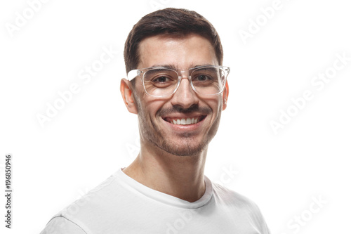Joyful modern optimistic man smiles broadly, shows perfect teeth isolated on white background. Positive emotions, facial expressions and happiness concept. © Damir Khabirov