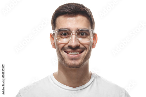 Close up headshot of smiling attractive man in white t-shirt and trendy trasparent eyeglasses isolated © Damir Khabirov