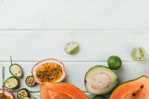 Assorted fruits colorful background on white wooden table.