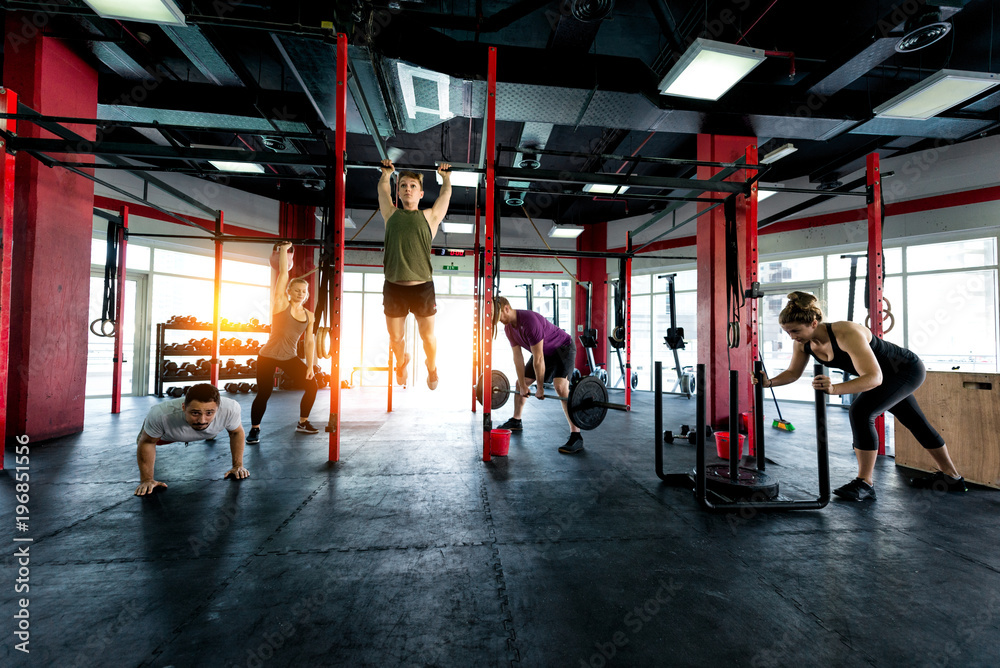 Fototapeta premium Athletes training in a cross-fit gym