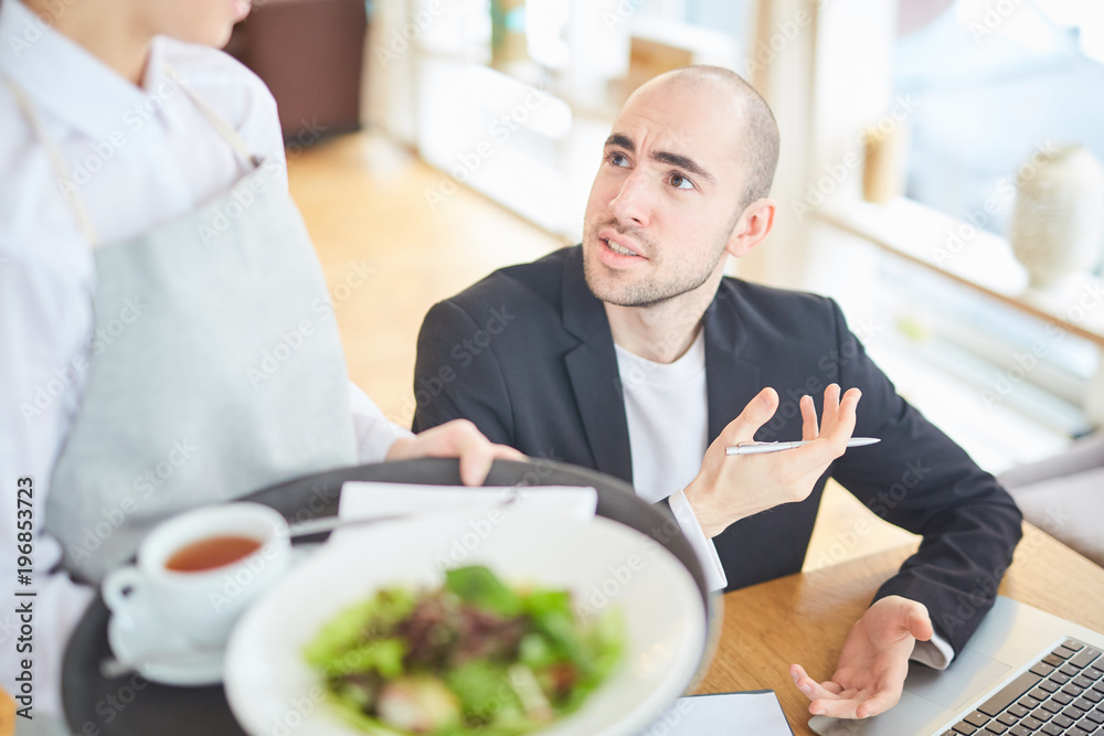 Businessman communicating with waiter about order at cafe Businessman communicating with waiter about order at cafe