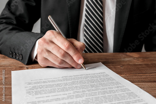 Businessman signing a document. photo