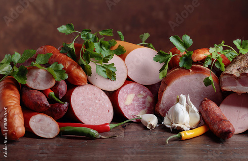 Fototapeta Naklejka Na Ścianę i Meble -  Different sausages and smoked meats on a  wooden table .