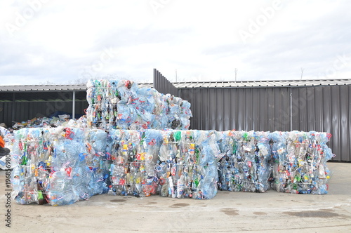 Compresed plastic bottler ready for recycling photo