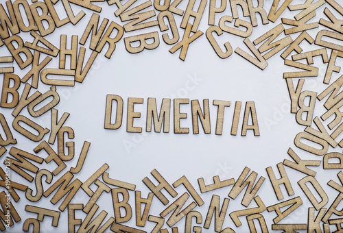 Foto Dementia word spelled with wooden letters against confusion of jumbled letters