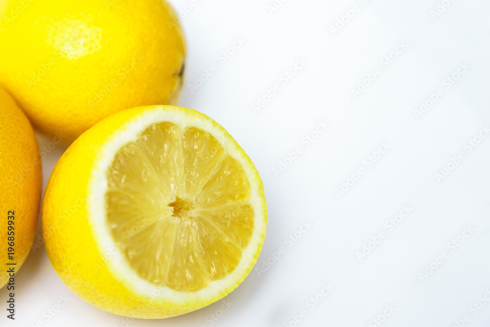 three yellow lemon one in a cut on a white background three yellow lemon one in a cut on a white background