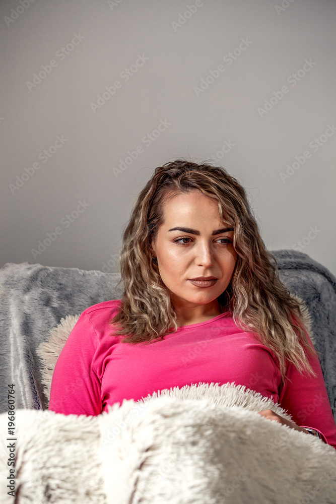 Beautiful woman lying in bed, enjoying and watching television at home. Beautiful woman lying in bed, enjoying and watching television at home.