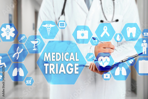 Medical Doctor with stethoscope and MEDICAL TRIAGE sign in Medical network connection on the virtual screen on hospital background.Technology and medicine concept. photo