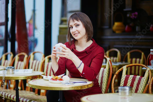 French woman drinking coffee in outdoor cafe in Paris  France
