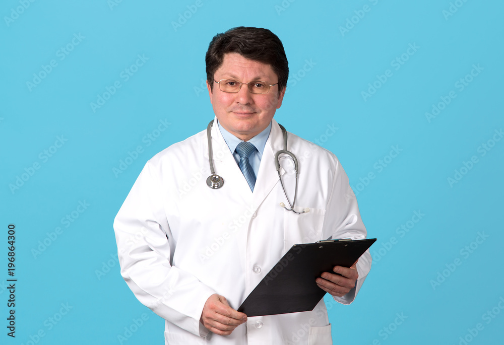 Portrait of middle-aged doctor on a blue background. Portrait of middle-aged doctor on a blue background.