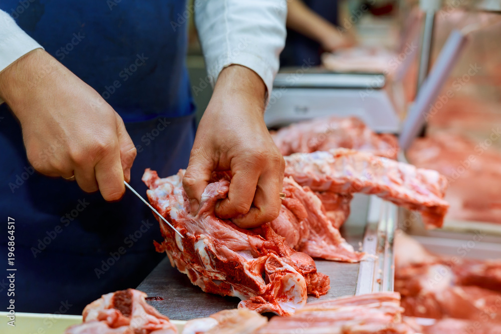 Carving raw meat. Raw meat curving on wooden background. Curving raw meat retail local market.